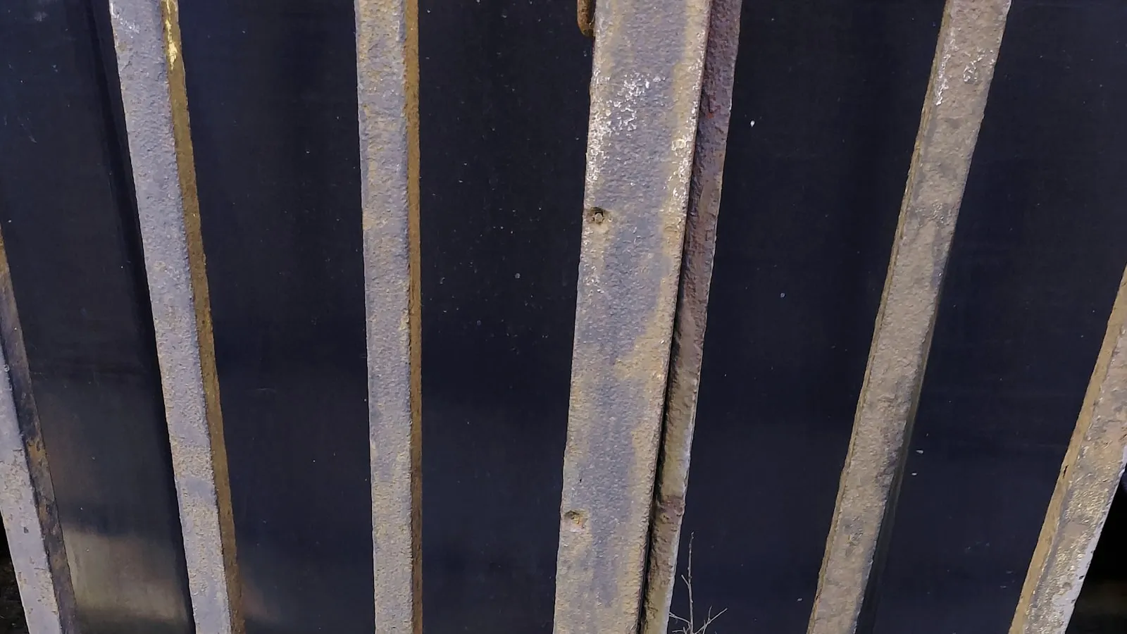Close-up of vertical metal gate bars