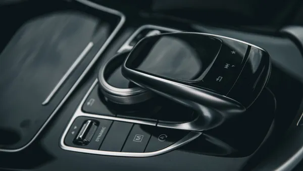 Premium car interior with rotary dial and drive-mode controls, dark and moody