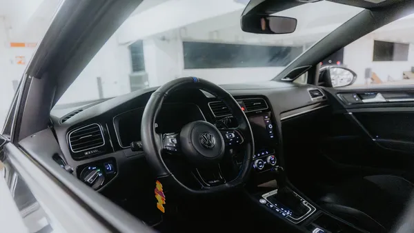 VW Golf R cabin interior showing steering wheel and dashboard in daylight