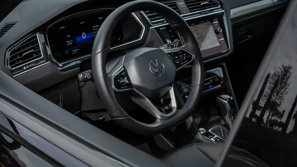 Modern car interior with a digital dashboard and steering wheel