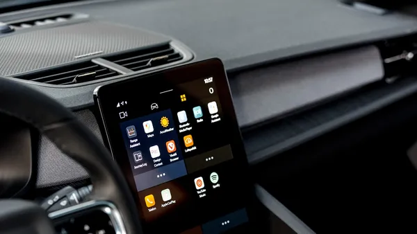 EV centre touchscreen showing an app grid and navigation icons on the dashboard