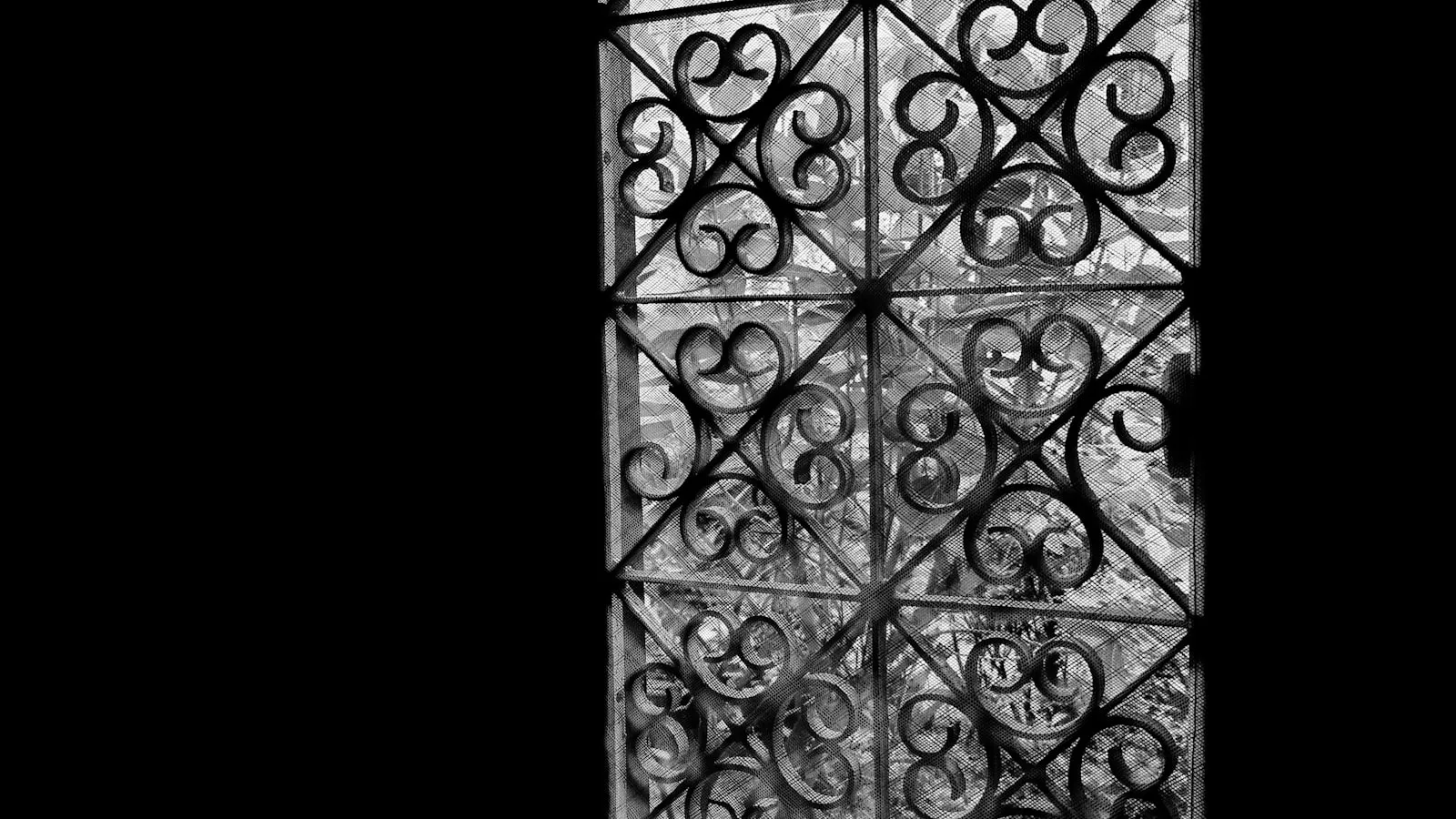 Ornate wrought iron gate against a dark background