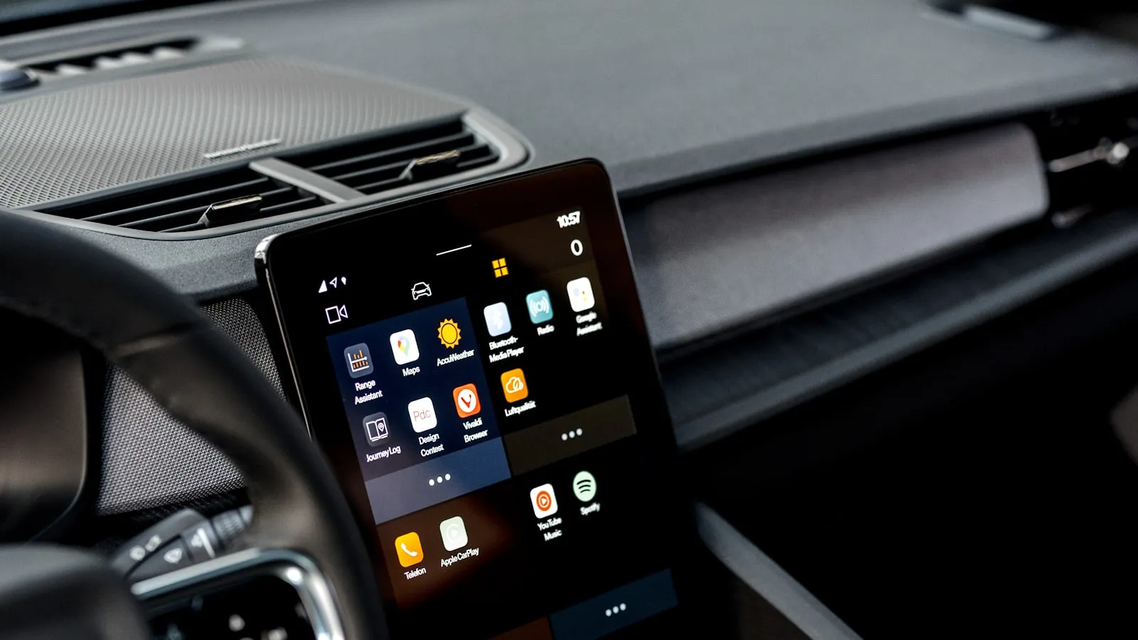 Modern premium EV interior showing the dashboard, steering wheel, and rearview mirror area