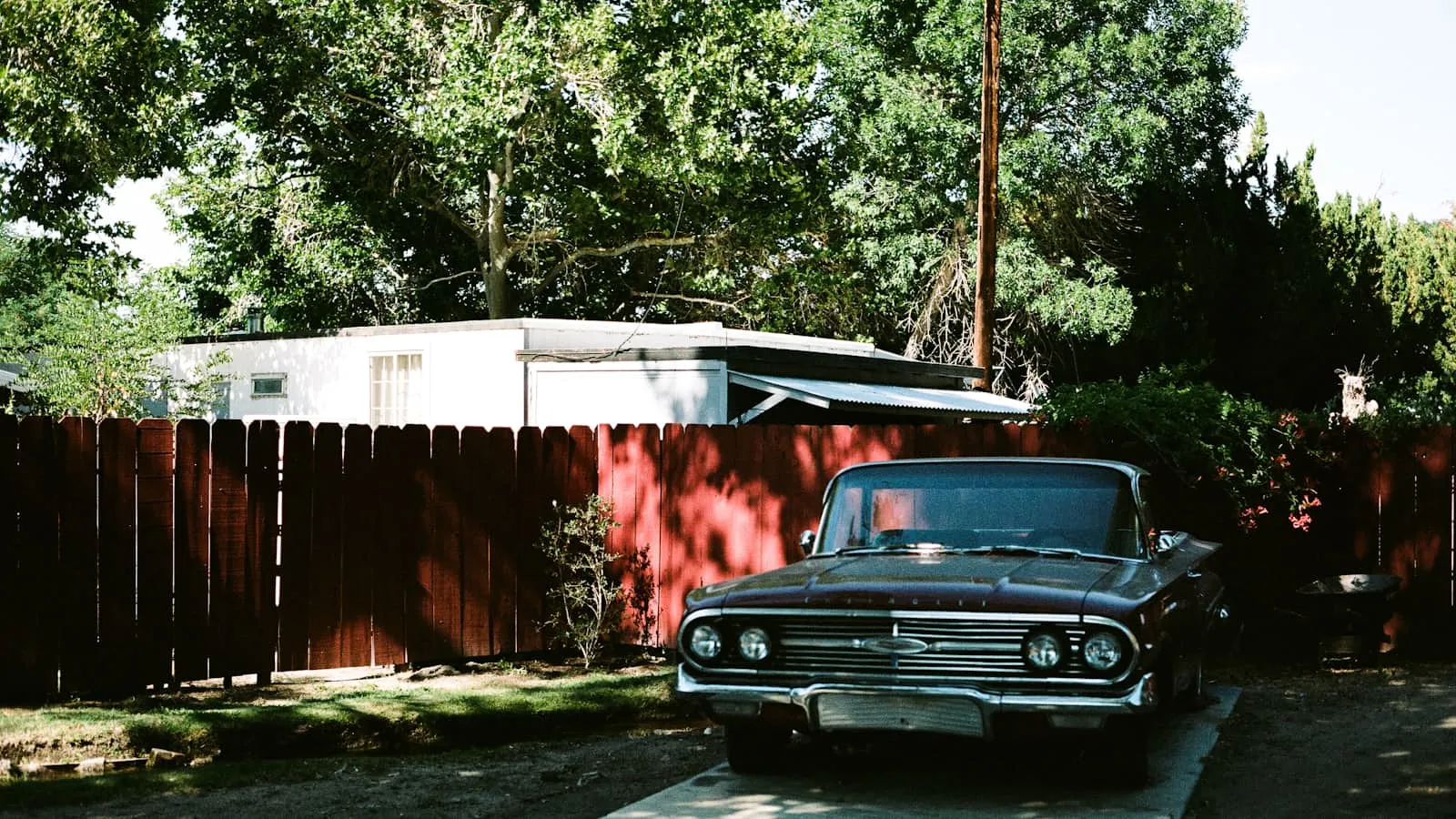 Car parked in a driveway next to a suburban house